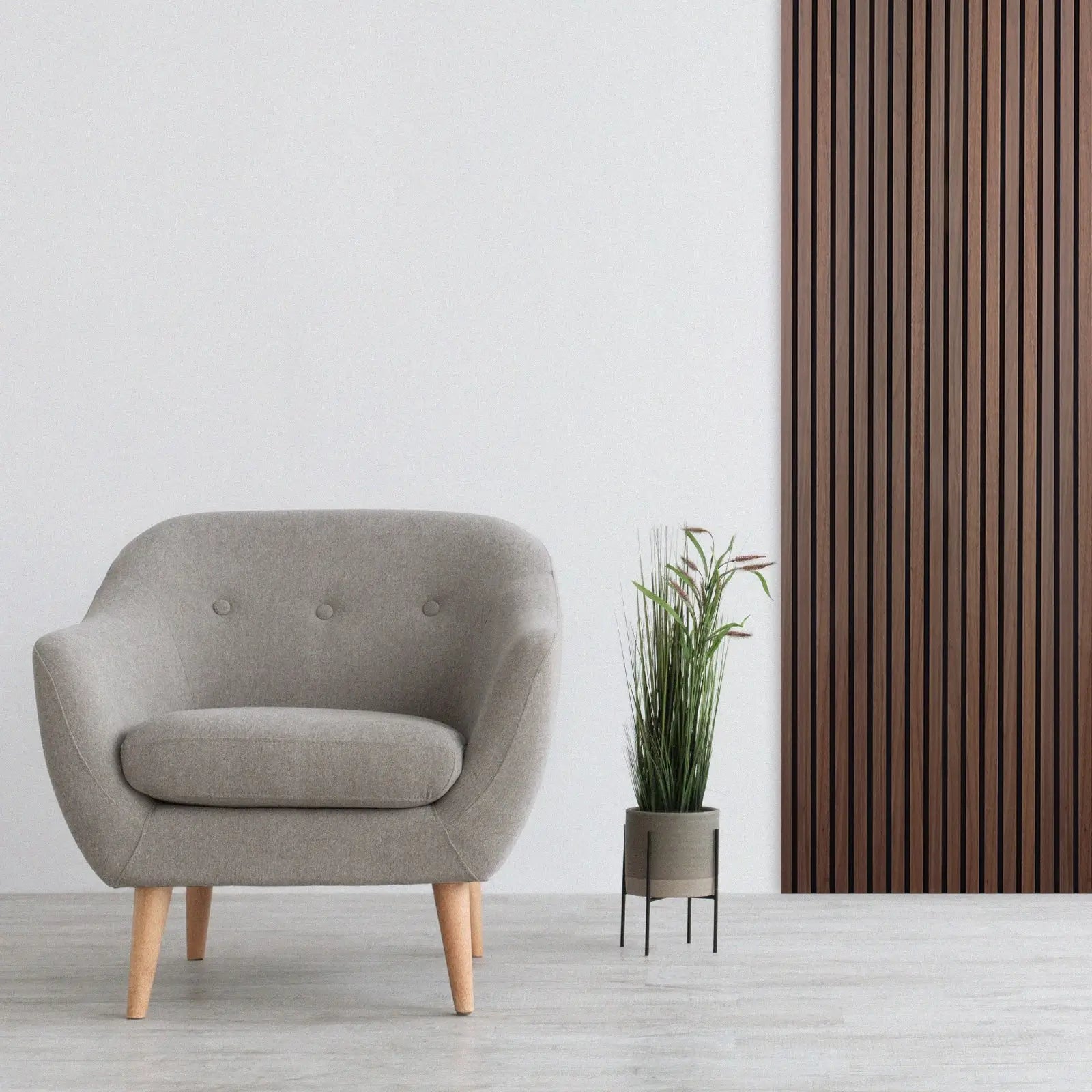 Gray upholstered armchair beside Acoustic Slat Wood Wall Panel in Smoked Oak