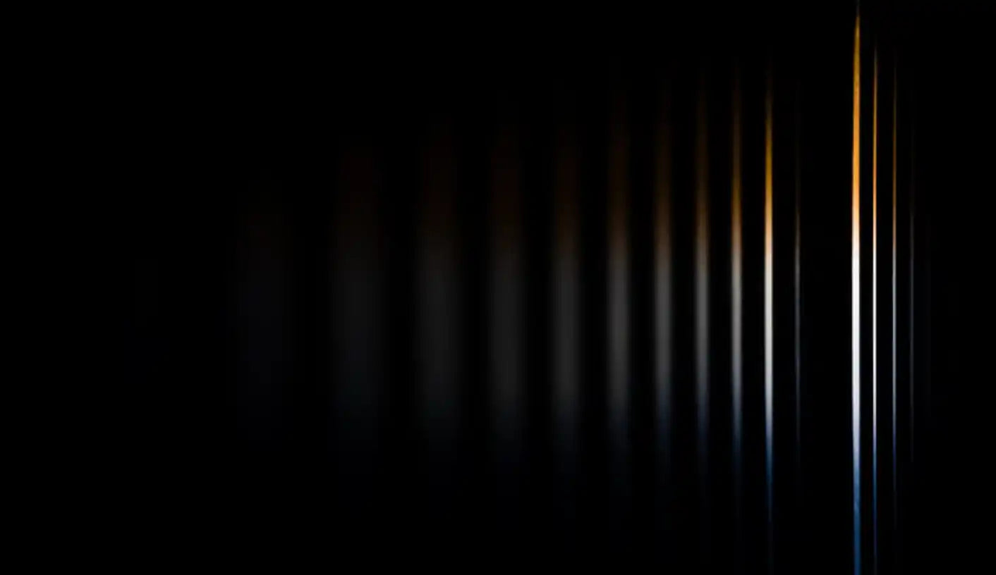 Vertical light bars fading from bright orange to dark blue against black.