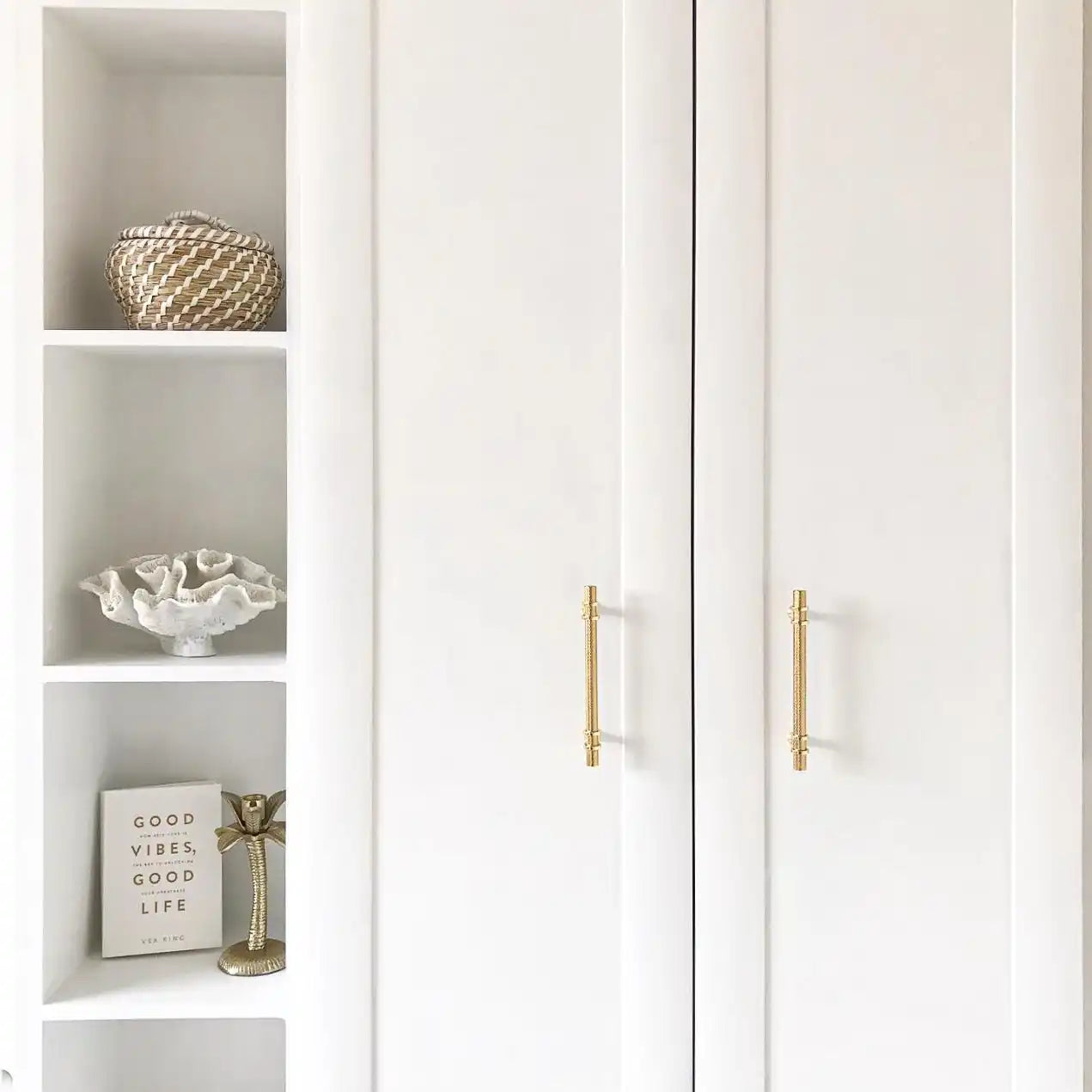 White closet doors with gold handles